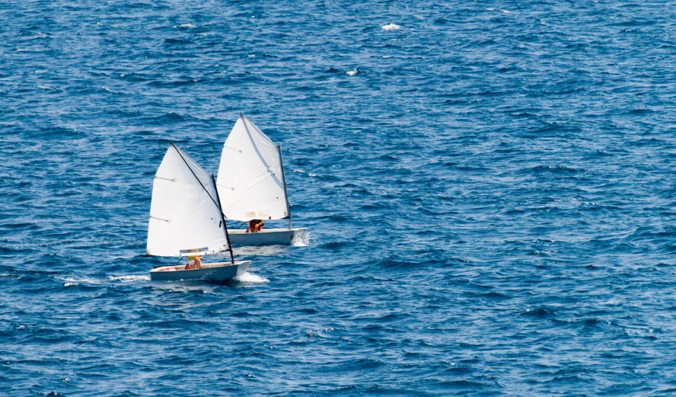 Sailboat Small racing sailboat in class "optimist". Training and practice.